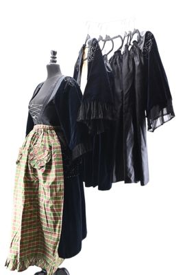 three dresses hanging on a clothes rack in front of a white background