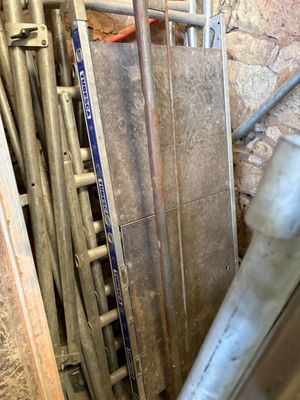 a pile of pipes and pipes in a room that is under construction