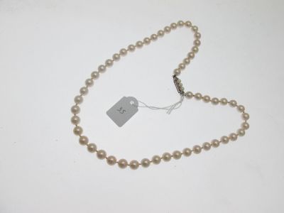un gros plan d'un collier de perles muni d'une étiquette