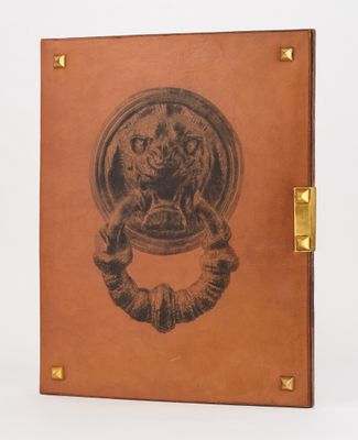 an old book with a picture of a lion on the cover