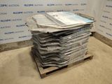 a stack of newspapers on a pallet in front of a wall