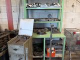 a green shelf with a bunch of tools on it
