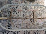 a bird cage with a bird inside of it on a rug