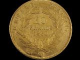 a close up of a gold coin on a black background