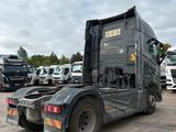 a truck that is parked in a lot with other trucks