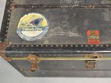 a black suitcase with a sticker on it sitting on a table