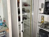 an image of a kitchen with a refrigerator in the corner