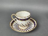 a cup and saucer with a blue and white design