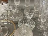 a lot of glassware on a table with a plate