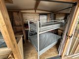 a bunk bed in the corner of a small room