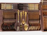 many forks and spoons in a brown box