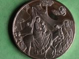an image of a silver coin with a nativity scene on it