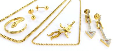 several pieces of gold jewelry are displayed on a white surface