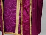 a close up of a purple and gold robe on a mannequin