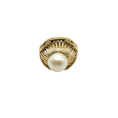 a close up of a ring with a pearl inside of it