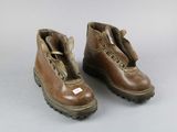 pair of brown leather boots with zippers on them on a white surface