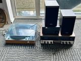 three speakers and a record player sitting on the floor