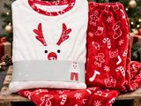 a close up of a christmas pajamas and a laptop on a wooden crate