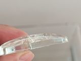 a person holding a clear plastic object in their hand