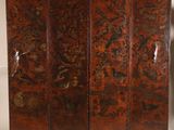 an old wooden screen with floral designs and birds on it