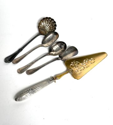 five spoons and a spatula on a white surface
