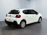 the rear of a white citrole parked in a garage