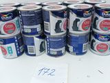 several cans of dog food are lined up on a table