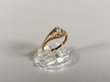 an image of a gold ring with a blue topaz stone