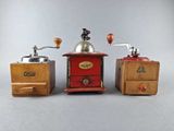 three different types of coffee grinders on a gray surface