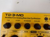 a close up of a yellow and black analog bass synthesizer
