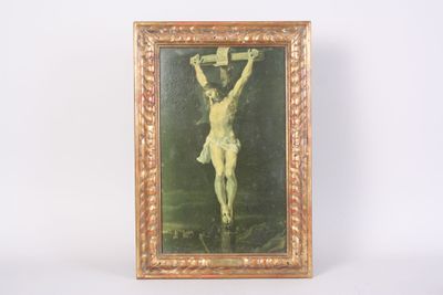 an old picture of jesus on the cross hanging on a wall