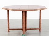 a close up of a wooden table with a glass on it