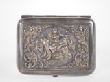 an antique silver belt buckle with an image of a man and a woman on a horse