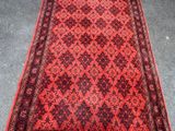 a red and black rug with a pattern on it