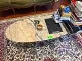 a coffee table with a marble top on a rug in a living room
