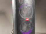 a close up of a speaker on a table with a white background