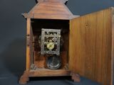 a wooden clock that is sitting in a wooden box