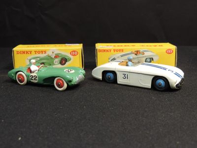two toy cars sitting next to each other on a table