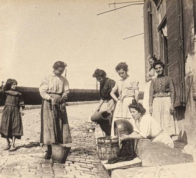 a group of women that are standing outside of a building