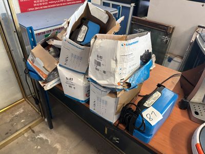 many boxes of electronic equipment sitting on a table