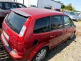 a red car that is parked in a parking lot