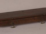 a small wooden box with hooks attached to it