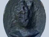 a black sculpture of a man with a hat on it
