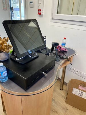 a laptop computer sitting on top of a wooden table