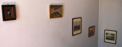 pictures on the wall above a toilet in a bathroom