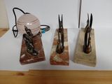 three pairs of scissors sitting on top of a table