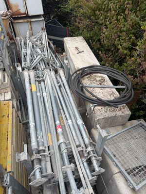 a pile of construction equipment sitting on the side of the road