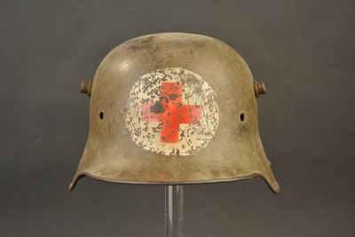 an old military helmet with a red cross painted on it