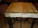 a wooden table with four stools around it
