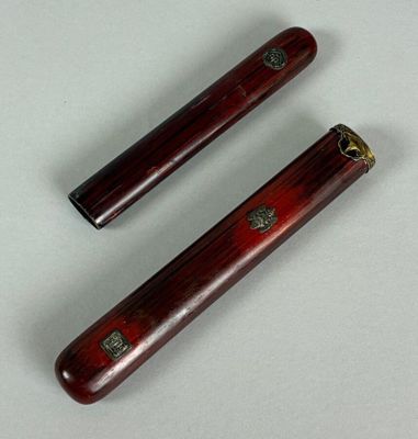 pair of antique chinese style wooden chopsticks on a white surface
